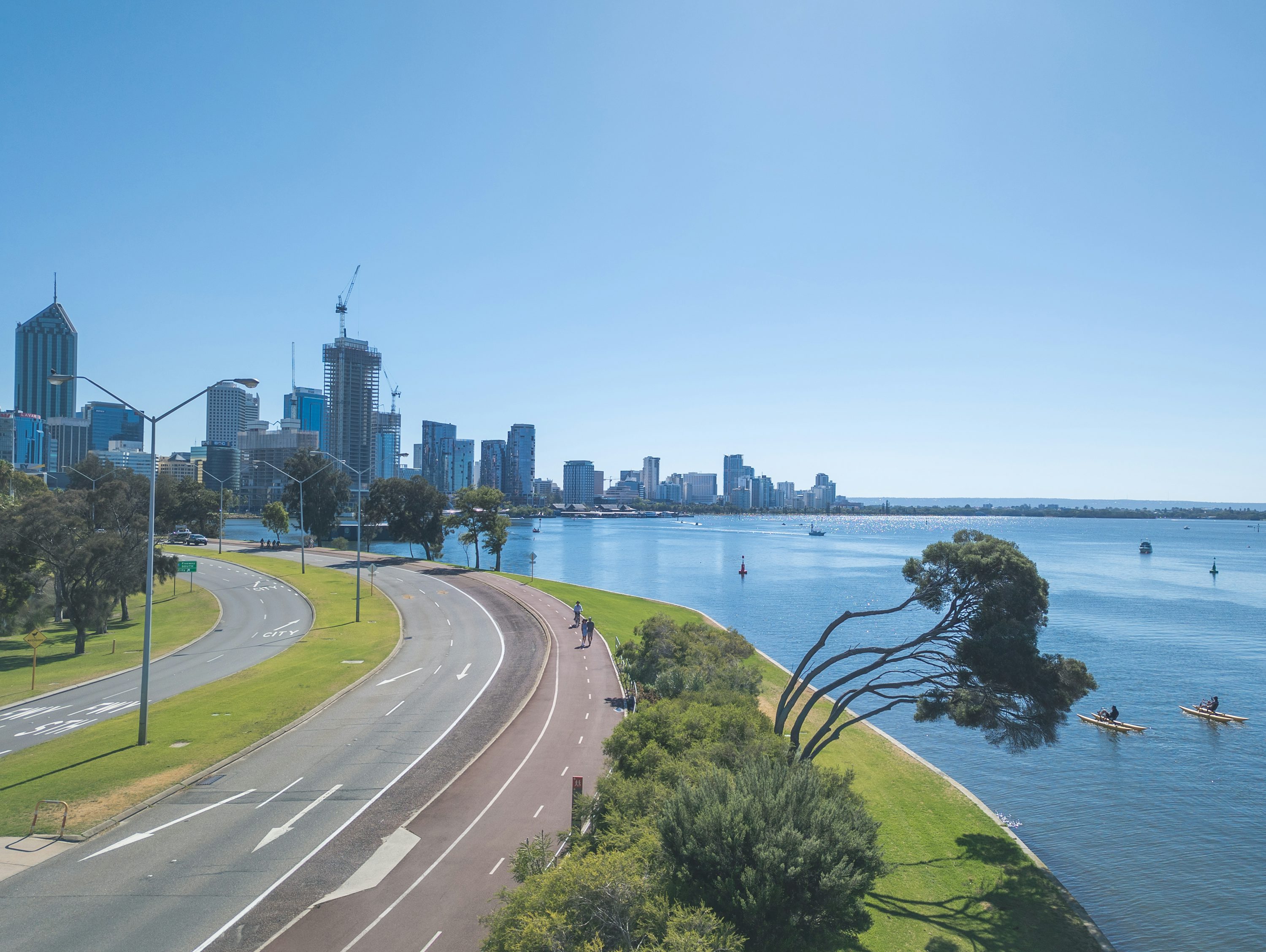The Perth city skyline seen across the Swan River, framed by the Narrows